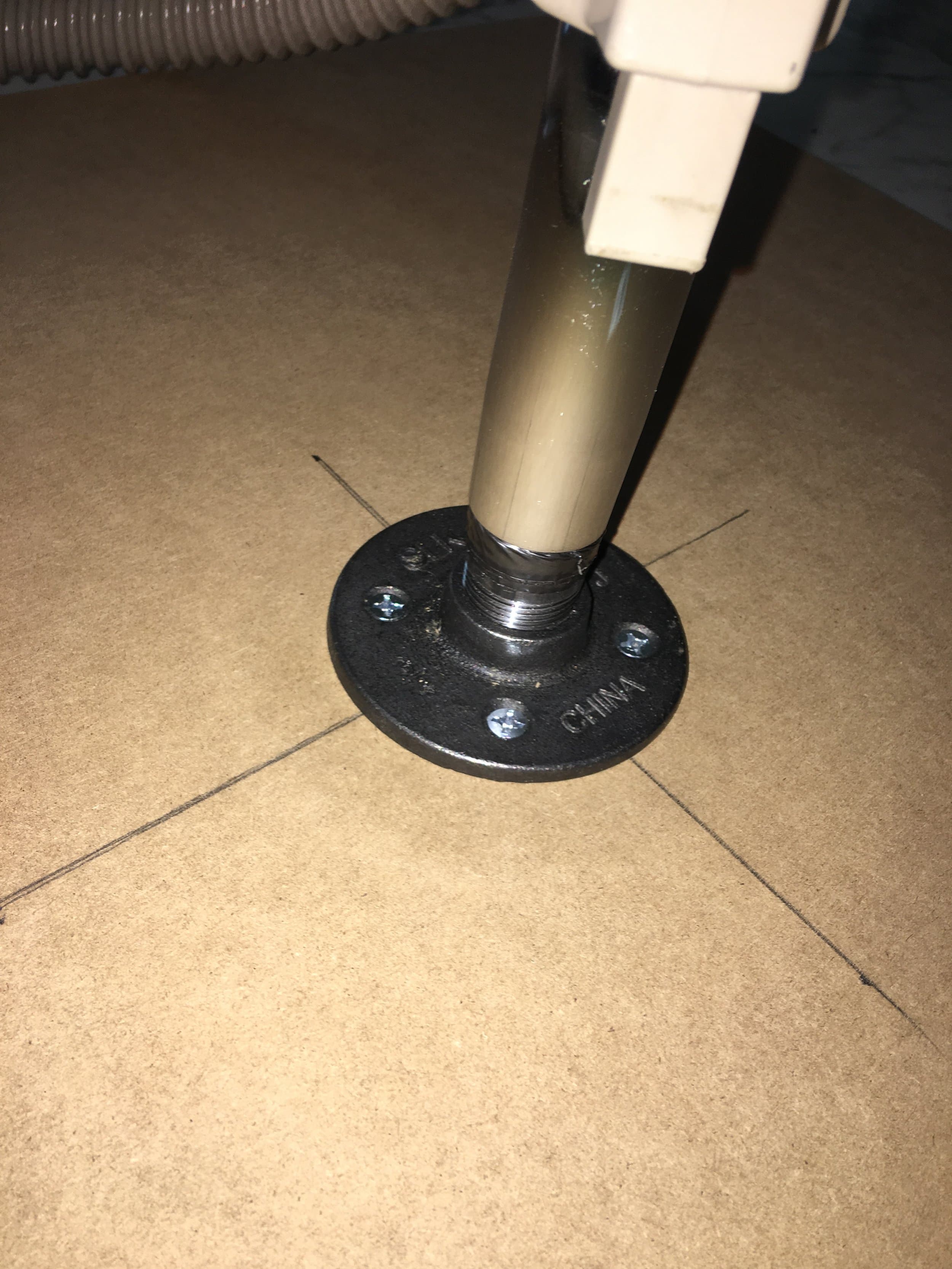 The vacuum former itself was made from a thick sheet of MDF. I drilled a hole through the middle and attached a metal flange to the bottom of the sheet.
